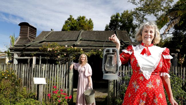 Volunteers Lynette Wilson (left) and Pam Hill pose in front of the Veivers early settlers cottage on display at the Gold Coast Historical Museum during the open day, Sunday, July 9, 2023. Photo: Regi Varghese