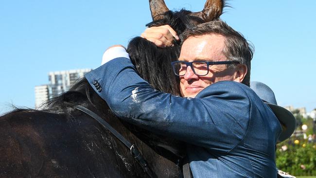 Trainer David Vandyke gives Alligator Blood a hug after his win. Picture: AAP