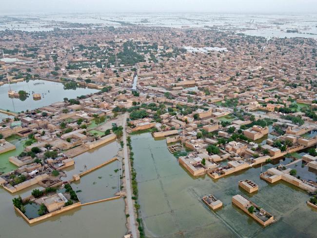 This aerial photograph taken on September 5, 2022 shows flooded residential areas after heavy monsoon rains in Dera Allah Yar, Balochistan province. - Nearly a third of Pakistan is under water -- an area the size of the United Kingdom -- following months of record monsoon rains that have killed 1,300 people and washed away homes, businesses, roads and bridges. (Photo by Fida HUSSAIN / AFP)