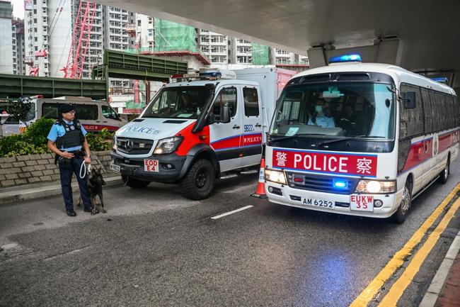 Police keep watch outside the West Kowloon Magistrates' Court in Hong Kong on Tuesday