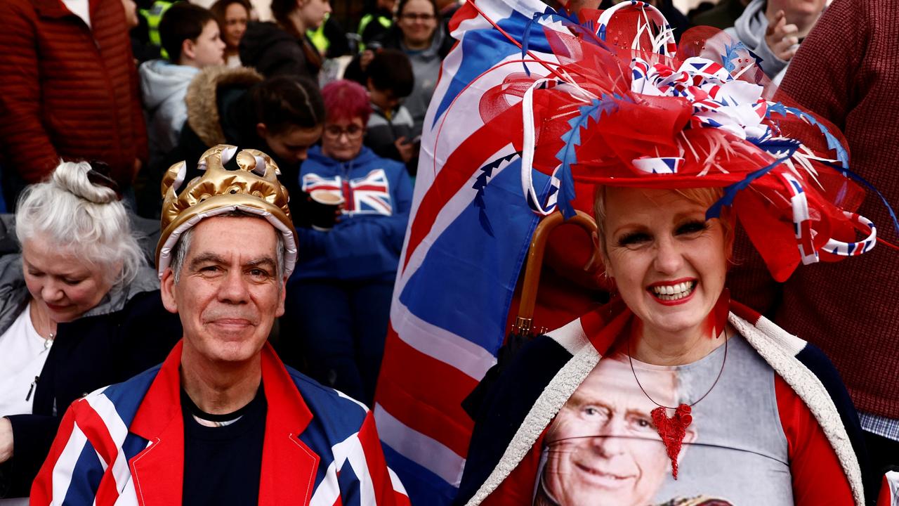 People wait to watch Britain's King Charles' procession to his coronation ceremony from Buckingham Palace to Westminster Abbey, at The Mall in London. Pictures: Yara Nardi