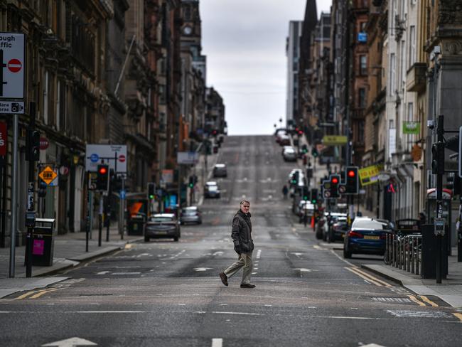 A man crosses the empty St Vincent Street in Glasgow, Scotland. Picture: Getty Images