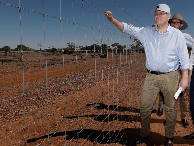 Prime Minister Scott Morrison inspects a dog-proof fence in far southwestern Queensland with Agriculture and Water Resources Minister David Littleproud. Picture: Alex Ellinghausen