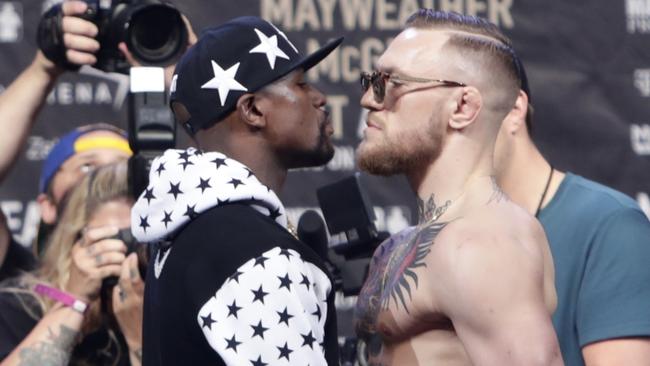 Floyd Mayweather Jr., left, and Conor McGregor, of Ireland, face off.