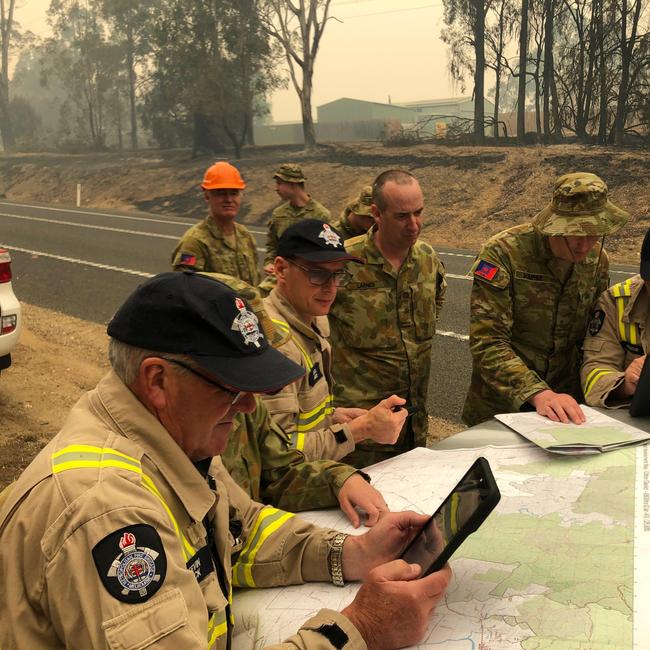 The Melbourne Fire Brigade and Australian Defence Force personnel work together to coordinate Damage Assessments in Sarsfield, East Gippsland.