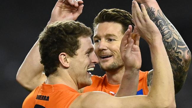 MELBOURNE, AUSTRALIA - AUGUST 13: Jacob Hopper of the Giants is congratulated by team mates after kicking a goal during the round 22 AFL match between Greater Western Sydney Giants and Richmond Tigers at Marvel Stadium on August 13, 2021 in Melbourne, Australia. (Photo by Quinn Rooney/Getty Images)