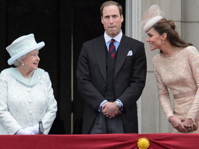 Catherine, Duchess of Cambridge (R) talks with Queen Elizabeth II as Prince William looks on on the balcony of Buckingham Palace. Picture: AFP