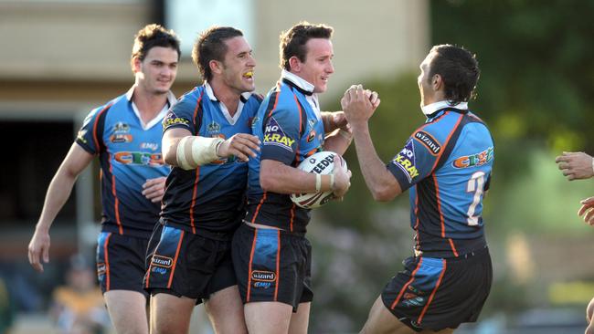 Chey Bird celebrates with Northern Pride teammates after scoring a try in the club’s inaugural Queensland Cup season in 2008.