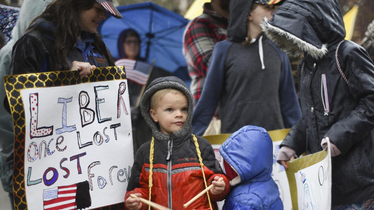 Abraham Eddy of Lapeer was one of eleven Eddy children protesting Governor Whitmer’s stay-at-home order in Michigan. Picture: AP