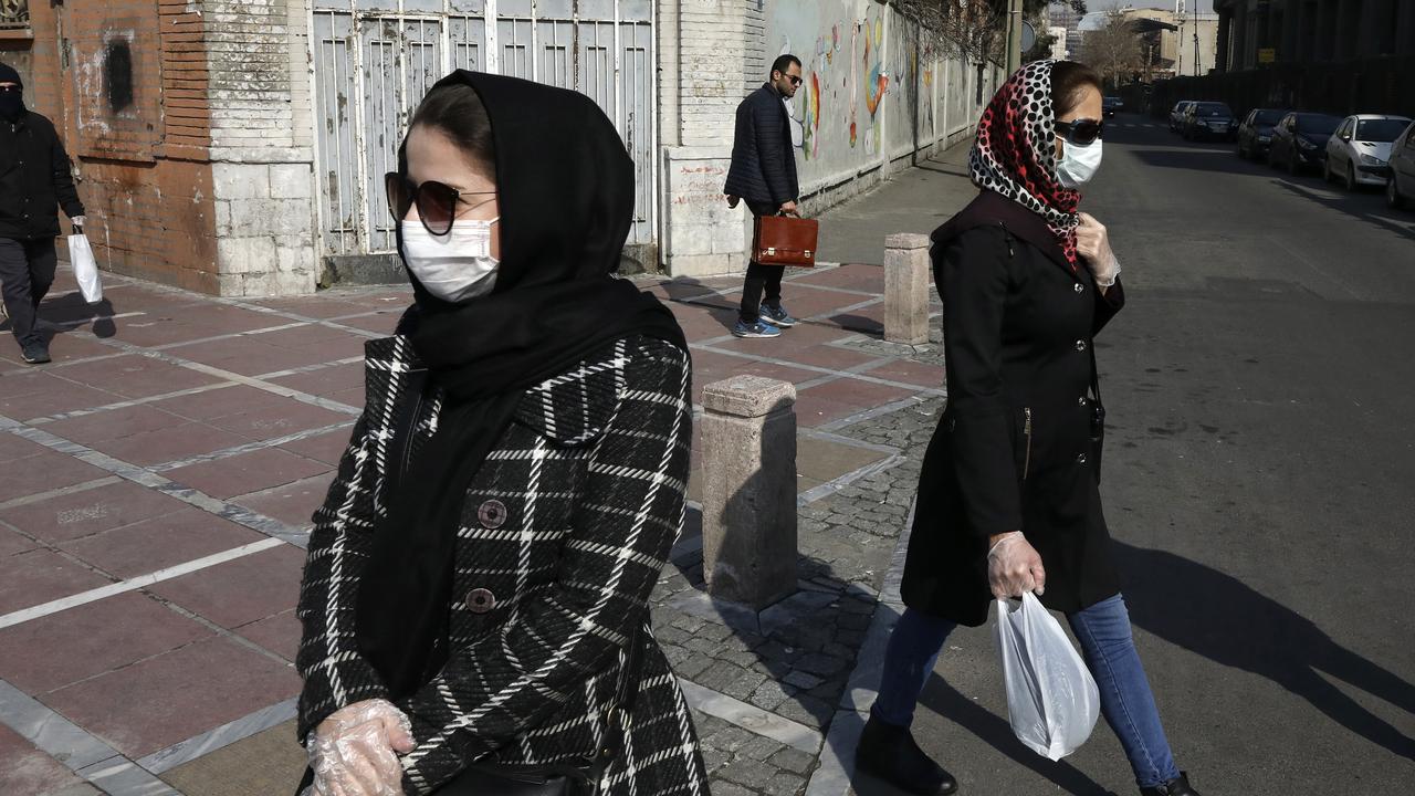 Pedestrians wear face masks and plastic gloves in downtown Tehran, Iran. Picture: AP/Vahid Salemi