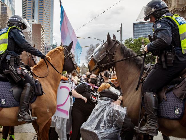 MELBOURNE, AUSTRALIA. NewsWire Photos. AUGUST 17, 2024. Mounted police hold back protesters from the Transgender Liberation group during a counter-protest against an anti-trans "women will speak" event at Parliament House Melbourne. Picture: NewsWire/Tamati Smith