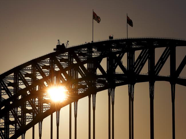 Sunrise over Sydney as the Covid-19 lockdown restrictions begin to ease after weeks of people being forced to work from home. The Sydney Harbour Bridge would normally have climbers on the arches getting a birds eye view of the sunrise but they remain empty due to social distancing restrictions. Picture: Toby Zerna