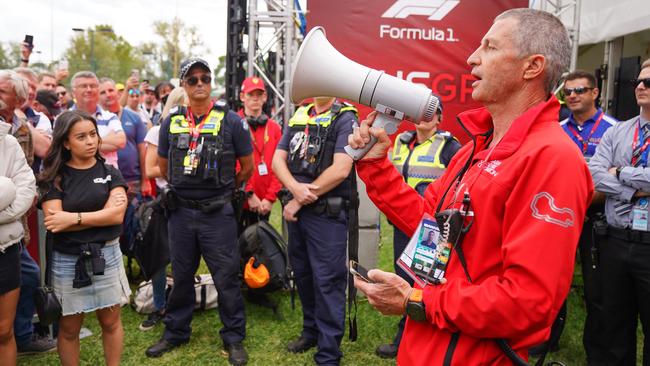 David Simpson from the The Australian Grand Prix Corporation announces to the crowd of spectators waiting at the gate that the Australian Grand Prix has officially been cancelled. Picture: AAP