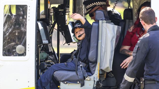 Sam Scully and Police Commissioner Grant Stevens arrive via Polair to Adelaide Oval. Picture: Russell Millard