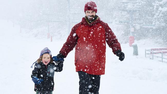 Paul Heginbothom and son George, 3, test the temperature at Thredbo on Wednesday. Picture: Rohan Thomson