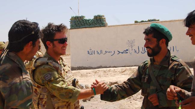 Phillip Thompson (second from the left) with members of the Afghan National Army at the Sarab check point prior to the Afghan Election. Picture: Corporal (CPL) Rachel Ingram