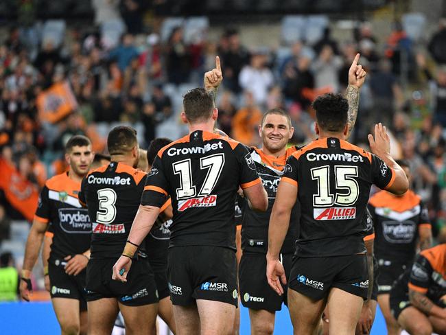 Tigers' player celebrate after winning the Round 19 NRL match between the Wests Tigers and the South Sydney Rabbitohs at ANZ Stadium in Sydney, Saturday, July 21, 2018. (AAP Image/Mick Tsikas) NO ARCHIVING, EDITORIAL USE ONLY