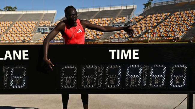 Gout Gout poses with the clock after winning the Men 200m Under 20 Finals during the Queensland Athletics Championships at Queensland Sport and Athletics Centre. (Photo by Albert Perez/Getty Images)