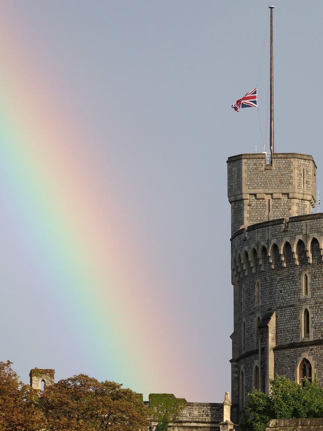 The Union flag is lowered on Windsor Castle as a rainbow covers the sky. Picture: Getty Images.