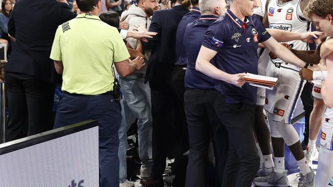 MELBOURNE, AUSTRALIA - NOVEMBER 17: A fight breaks out on the Adelaide 36ers interchange as member of the crowd gets involved with the players on the bench during the round nine NBL match between Melbourne United and Adelaide 36ers at John Cain Arena, on November 17, 2024, in Melbourne, Australia. (Photo by Darrian Traynor/Getty Images)