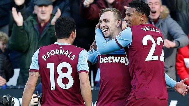 West Ham United's English striker Jarrod Bowen (C) celebrates scoring the opening goal with West Ham United's French striker Sebastien Haller (R) and West Ham United's Spanish midfielder Pablo Fornals during the English Premier League football match between West Ham United and Southampton at The London Stadium, in East London on February 29, 2020. (Photo by Ian KINGTON / AFP) / RESTRICTED TO EDITORIAL USE. No use with unauthorised audio, video, data, fixture lists, club/league logos or 'live' services. Online in-match use limited to 120 images. An additional 40 images may be used in extra time. No video emulation. Social media in-match use limited to 120 images. An additional 40 images may be used in extra time. No use in betting publications, games or single club/league/player publications. /