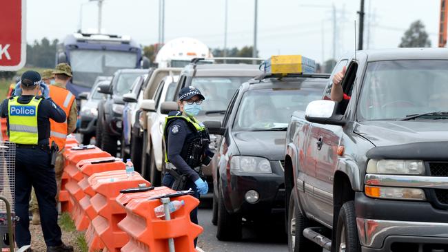 Victorian police and Australian defence personnel manage roadside checkpoints near Donnybrook to enforce coronavirus travel restrictions in 2020. Picture: Andrew Henshaw