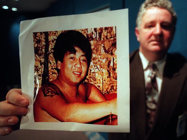 Vic police officer Rod Collins holding picture of kidnapping and murder victim Tuan Anh Le./Murder/Victoria