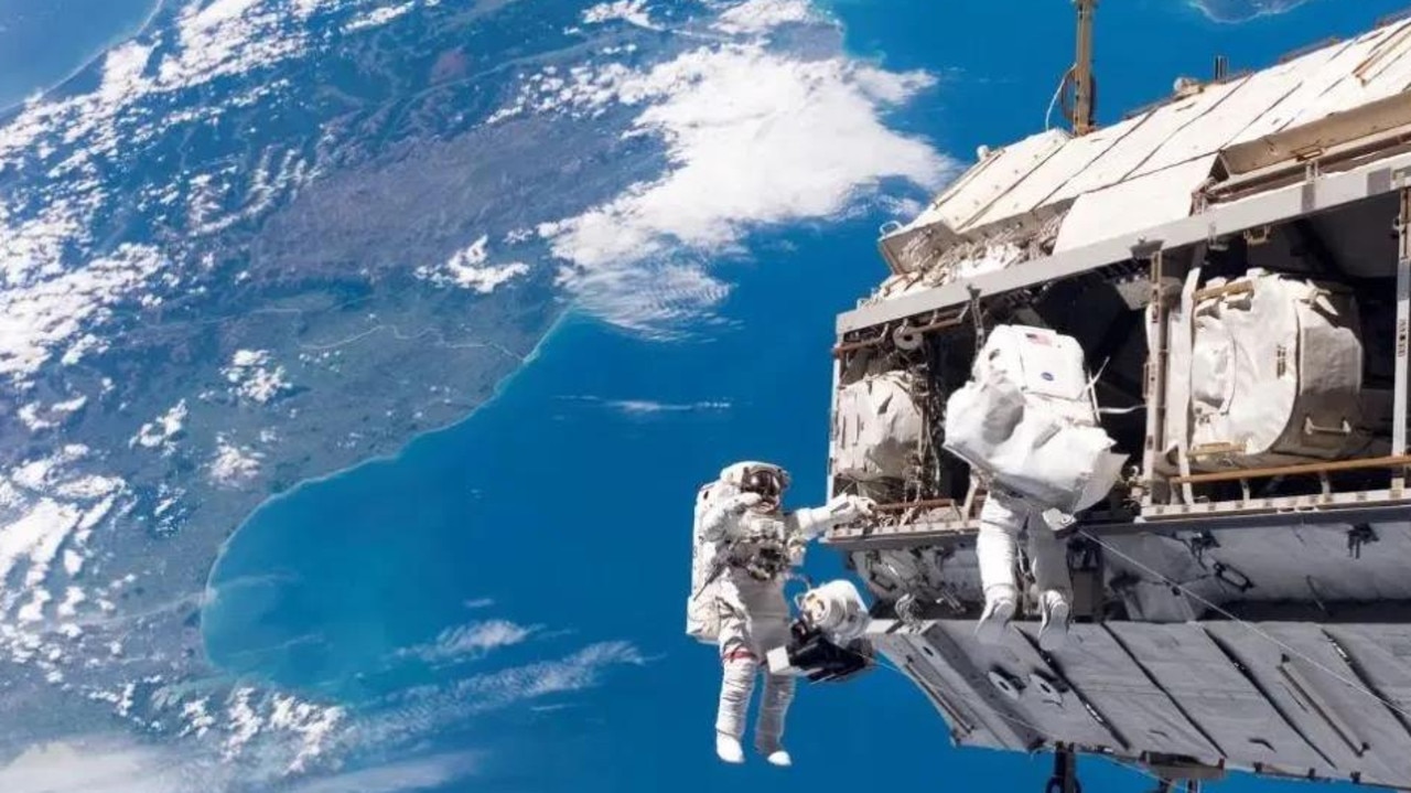 Astronauts work outside the International Space Station with New Zealand and the Cook Strait in the Pacific Ocean in the background. Picture: NASA