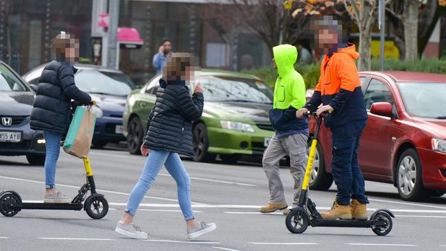 Scooter riders without helmets cross Pulteney St. Picture: Brenton Edwards