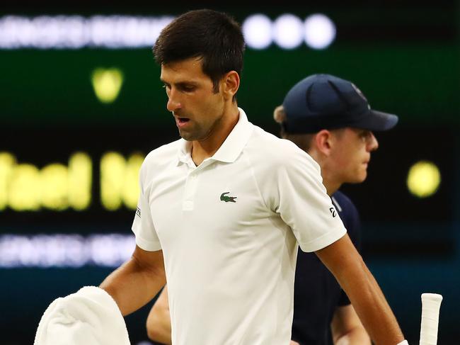 LONDON, ENGLAND - JULY 13:  Novak Djokovic of Serbia leaves Centre Court after his Men's Singles semi-final match against Rafael Nadal of Spain was suspended on day eleven of the Wimbledon Lawn Tennis Championships at All England Lawn Tennis and Croquet Club on July 13, 2018 in London, England.  (Photo by Michael Steele/Getty Images)