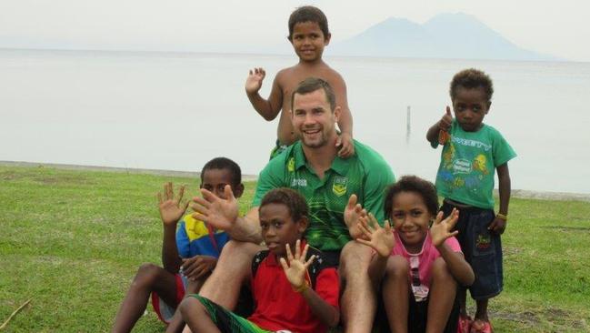Brenton Lawrence with some local fans in PNG