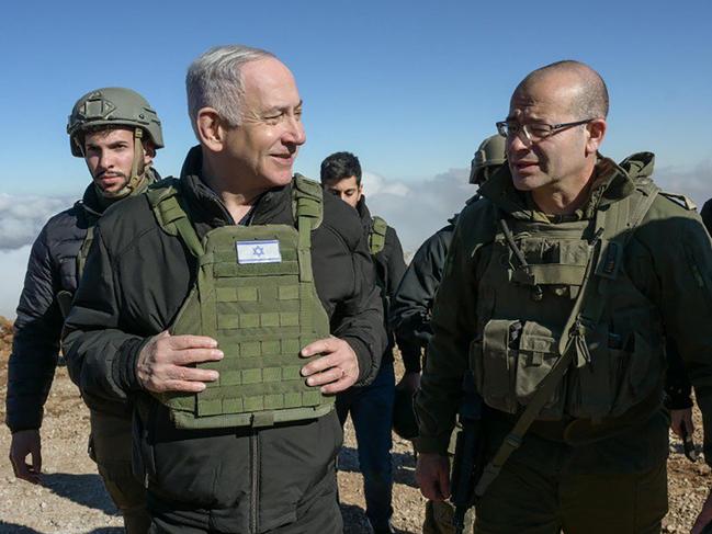 This handout picture released by the Government Press Office (GPO) shows Israeli Prime Minister Benjamin Netanyahu (L) walking among members of the Israeli army at Mount Hermon in the annexed Golan Heights, on December 17, 2024. Netanyahu held a security briefing on December 17, atop a strategic Syrian mountain inside the UN-patrolled buffer zone on the Golan Heights that Israel seized this month, the defence minister said. (Photo by GPO / AFP) / Israel OUT / XGTY / === RESTRICTED TO EDITORIAL USE - MANDATORY CREDIT "AFP PHOTO / Handout /GPO' - NO MARKETING NO ADVERTISING CAMPAIGNS - DISTRIBUTED AS A SERVICE TO CLIENTS ==