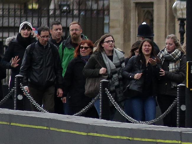 Pedestrians leave after being evacuated from Westminster. Picture: AFP