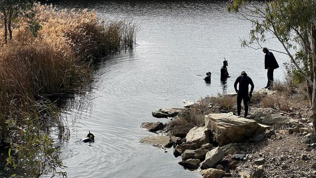 Police divers search a river near Spalding, in the state’s Mid North, for the murder weapon thought to have been used in the death of Robert Atkins. Picture: NCA NewsWire/Emma Brasier