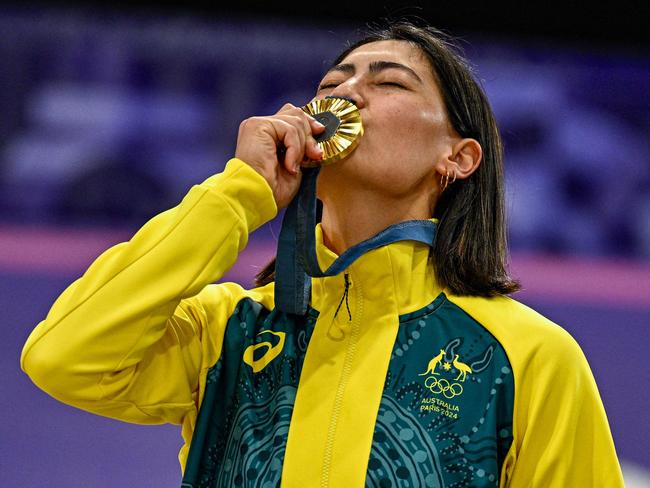 Saya Sakakibara kisses her gold medal standing on the podium after winning the Women's Cycling BMX Racing finals. Picture: Julien De Rosa / AFP