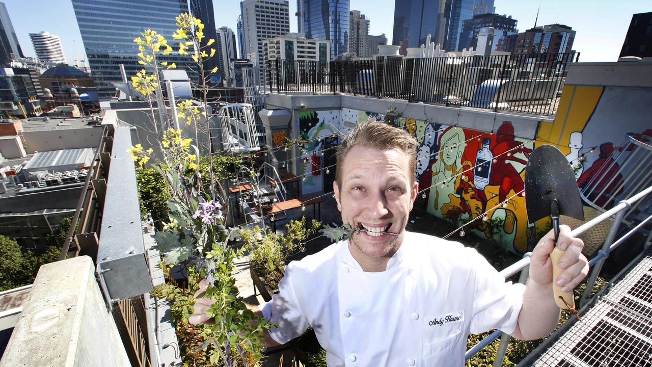 QT Melbourne executive chef Andy Harmer with some herbs on their secret rooftop garden, which grows produce that is then used in the venue's kitchen. Picture: David Caird