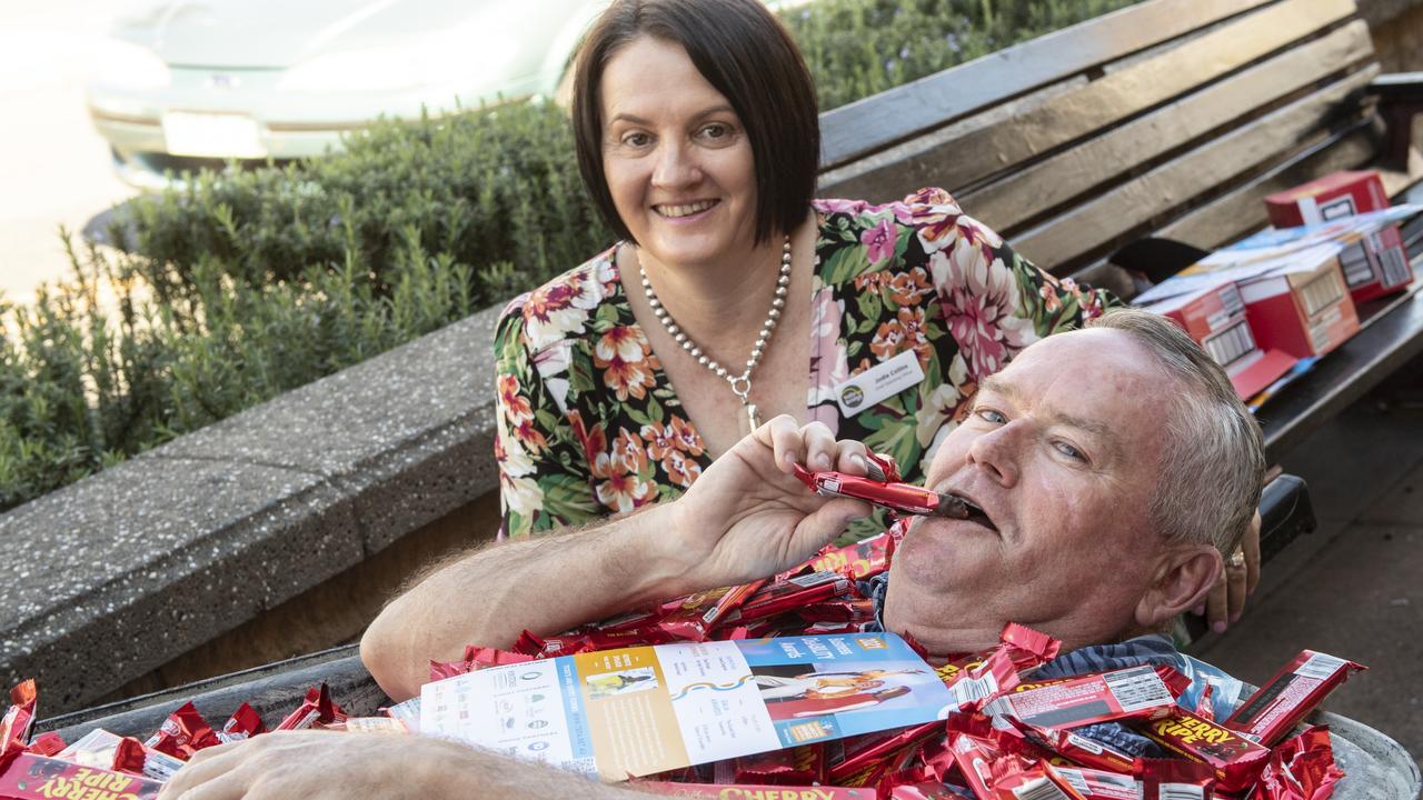 YellowBridge COO Jodie Collins and volunteer Daryl Nicholson giving away chocolate bars in the CBD to raise awareness for the Disability Business Awards. Picture: Nev Madsen.