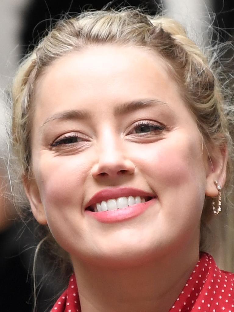 Amber Heard all smiles before going into court.