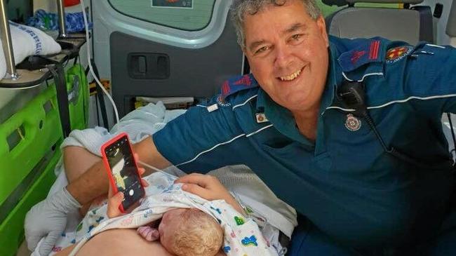 Mum Shontelle Hall with baby Andrew in the back of the ambulance with Zilzie station ambulance officer, Andrew Green. Picture: Contributed