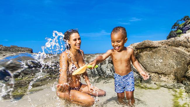 Chloe Matterson from Elanora with her 3-year-old son Carter cool off at a Froggy Beach on the Gold Coast. The pair are ready for the weather to clear up. Picture: NIGEL HALLETT