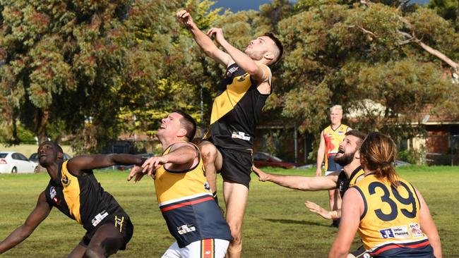 St Paul's Old Scholars’ Anthony Alesiani goes up for a mark during a previous clash against Trinity Old Scholars. Alesiani was one of the Saints’ best on Saturday. Picture: Hannah Rex/On the Ball Media