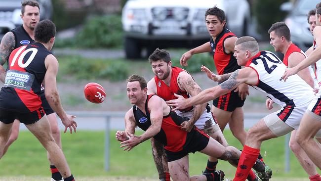 Former Morphett Vale player Braden Bayly, pictured handballing in a game in 2016, has been appointed the Emus’ new senior coach. Picture: Stephen Laffer