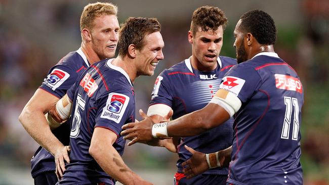 Dane Haylett-Petty of the Rebels celebrates a try with teammates.