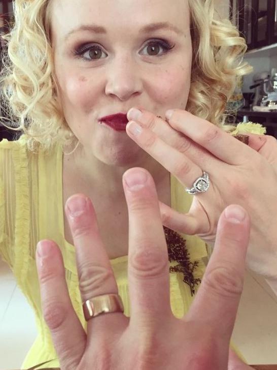 Showing off their wedding bands.