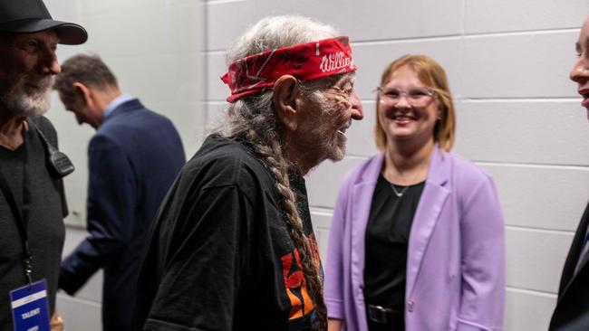 Willie Nelson greets wellwishers lining up to meet Kamala Harris backstage before she was due to speak. Picture: Roberto Schmidt / AFP