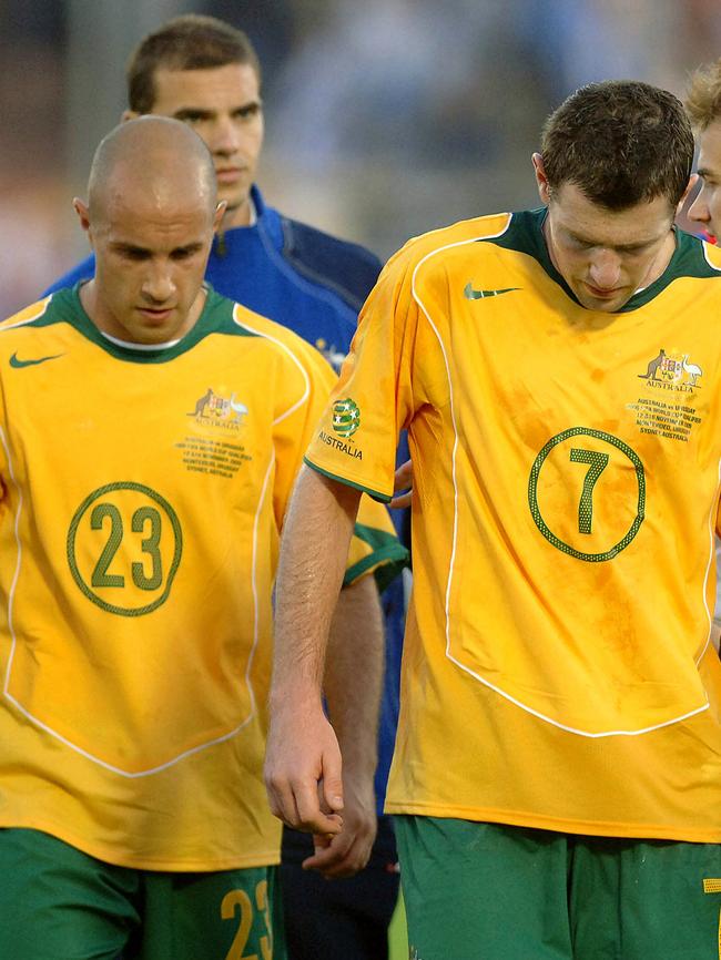 Bresciano and Brett Emerton leave the field after going down 1-0 to Uruguay in their first leg in 2005