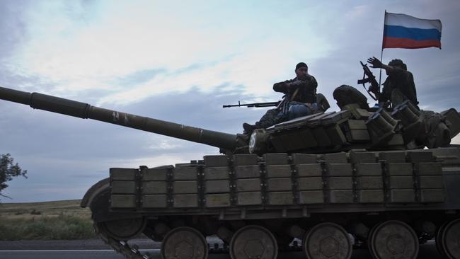 A tank flying the Russian flag seen on the road from the rebel-controlled Donetsk pulling back to the Russian border days after the MH17 crash in the area on July 21 2014. Picture: Ella Pellegrini.