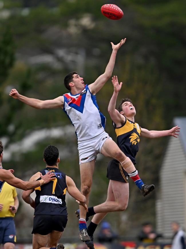 NFL: West Preston-Lakeside’s Matthew Harman jumps over Whittlesea’s Sam Indian. Picture: Andy Brownbill