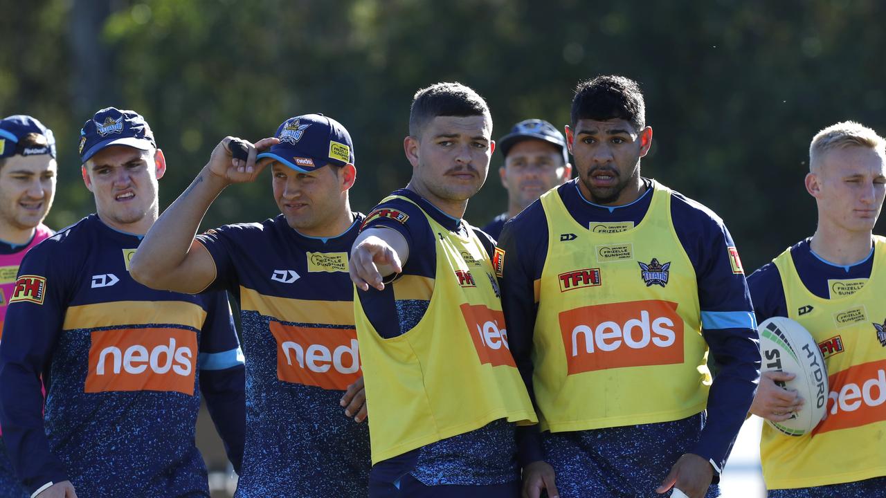 Ashley Taylor talks to Treymain Spry of the Gold Coast Titans during a training session