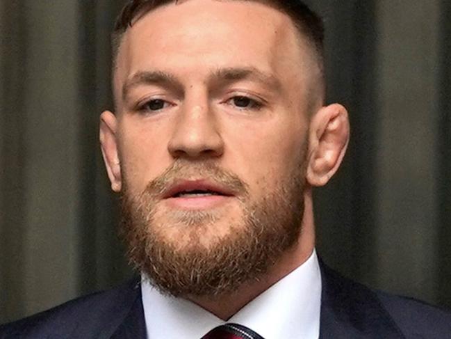 (FILES) Irish mixed martial arts fighter Conor McGregor (C) arrives to talk to the press after he pleaded guilty to a single violation of disorderly conduct in Brooklyn Criminal Court, on July 26, 2018. A woman on November 22, 2024 won civil court damages claim against mixed martial arts (MMA) fighter Conor McGregor over her allegation that he raped her in a Dublin hotel in 2018. (Photo by TIMOTHY A. CLARY / AFP)